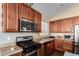 Modern kitchen with stainless steel appliances and wood cabinets at 3946 E Pollack St, Phoenix, AZ 85042