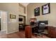 Home office with wood desk, multiple monitors, and wood floors at 3946 E Pollack St, Phoenix, AZ 85042