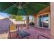 Relaxing covered patio with seating area, umbrella, and grill at 3946 E Pollack St, Phoenix, AZ 85042