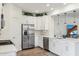 Modern kitchen with white cabinets, stainless steel appliances and large island at 4026 E Madre Del Oro Dr, Cave Creek, AZ 85331