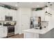 Modern kitchen with white cabinets, stainless steel appliances and breakfast bar at 4026 E Madre Del Oro Dr, Cave Creek, AZ 85331