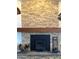 Stone fireplace with wood storage and black insert at 45239 N 16Th St, New River, AZ 85087