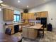 Bright kitchen boasts an island, lots of wood cabinets, and tile floors at 45239 N 16Th St, New River, AZ 85087