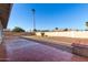 Spacious backyard with brick patio and mature palm trees at 4538 W Sierra St, Glendale, AZ 85304