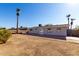 View of the home's back and the backyard with patio at 4538 W Sierra St, Glendale, AZ 85304