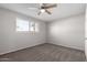 Spacious bedroom with ceiling fan and carpet flooring at 4538 W Sierra St, Glendale, AZ 85304