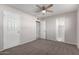 Bedroom with ceiling fan, carpet, and access to a full bathroom at 4538 W Sierra St, Glendale, AZ 85304