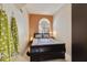 Cozy bedroom with a sleigh bed, orange accent wall, and plenty of natural light at 4602 E Monte Way, Phoenix, AZ 85044