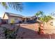 Home with solar panels and a spacious backyard with desert landscaping at 521 W Jardin Loop, Casa Grande, AZ 85122