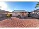 Backyard view of home with solar panels and covered patio at 521 W Jardin Loop, Casa Grande, AZ 85122