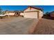 One-story house with a two-car garage and rock landscaping at 521 W Jardin Loop, Casa Grande, AZ 85122