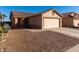 One-story house with a two-car garage and rock landscaping at 521 W Jardin Loop, Casa Grande, AZ 85122