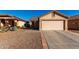 One-story house with a two-car garage and desert landscaping at 521 W Jardin Loop, Casa Grande, AZ 85122