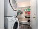 Stackable washer and dryer in a spacious laundry room with storage shelves at 521 W Jardin Loop, Casa Grande, AZ 85122