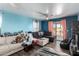 Living room with sectional couch, gray beanbag chair, and blue walls at 521 W Jardin Loop, Casa Grande, AZ 85122