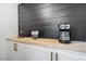 Modern coffee bar with wood countertop, built-in cabinets, and coffee maker at 5238 N 42Nd Ln, Phoenix, AZ 85019