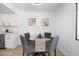 Modern dining area with glass table and four gray chairs at 5238 N 42Nd Ln, Phoenix, AZ 85019