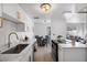 Open concept kitchen with white cabinets, marble countertops and stainless steel appliances at 5238 N 42Nd Ln, Phoenix, AZ 85019