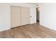 Bedroom with double door closet and light hardwood floors at 5238 Nw 42Nd Ln, Phoenix, AZ 85019