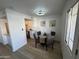 Bright dining area with a glass table and four chairs, adjacent to kitchen at 5238 Nw 42Nd Ln, Phoenix, AZ 85019