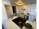 Modern kitchen with sleek black cooktop and white cabinetry at 5238 Nw 42Nd Ln, Phoenix, AZ 85019