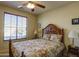 Bedroom with a floral comforter and ceiling fan at 5491 W Pueblo Dr, Eloy, AZ 85131