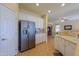 Kitchen with stainless steel refrigerator, white cabinets and breakfast bar at 5491 W Pueblo Dr, Eloy, AZ 85131