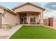 Landscaped front yard with artificial turf and porch at 5711 W Lydia Ln, Laveen, AZ 85339