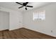 Well-lit bedroom with hardwood floors and a ceiling fan at 5921 W Hearn Rd, Glendale, AZ 85306