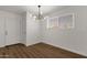 Bright dining area with wood floors and modern light fixture at 5921 W Hearn Rd, Glendale, AZ 85306