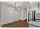 Dining area with wood floors and a modern light fixture at 5921 W Hearn Rd, Glendale, AZ 85306