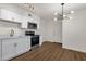 Bright kitchen with white cabinets, stainless steel appliances, and wood floors at 5921 W Hearn Rd, Glendale, AZ 85306