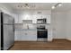 Modern kitchen featuring white cabinets and stainless steel appliances at 5921 W Hearn Rd, Glendale, AZ 85306