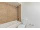 Bathroom with a shower/tub combo and tile surround at 604 W Emerald Ave, Mesa, AZ 85210