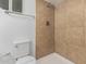 Updated bathroom with brown tile shower and white toilet at 604 W Emerald Ave, Mesa, AZ 85210