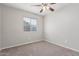 Bright bedroom with carpeted floor, ceiling fan, and window coverings at 604 W Emerald Ave, Mesa, AZ 85210