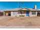 Single story home with blue door and landscaped yard at 604 W Emerald Ave, Mesa, AZ 85210