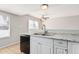 Kitchen features white cabinets and a double sink at 604 W Emerald Ave, Mesa, AZ 85210