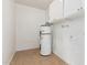 Laundry room with water heater and upper cabinets at 604 W Emerald Ave, Mesa, AZ 85210