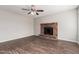 Living room featuring a brick fireplace and ceiling fan at 604 W Emerald Ave, Mesa, AZ 85210