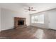 Living room with brick fireplace and wood-look flooring at 604 W Emerald Ave, Mesa, AZ 85210