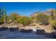 Relaxing backyard patio with fire pit and stone seating at 617 S Camino Saguaro --, Apache Junction, AZ 85119