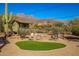 Landscaped backyard with fire pit and artificial turf at 617 S Camino Saguaro --, Apache Junction, AZ 85119