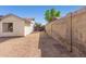 Sandy backyard with a block wall and wooden fence at 6602 W Desert Cove Ave, Glendale, AZ 85304