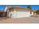 House exterior showcasing a white garage door and landscaping at 6602 W Desert Cove Ave, Glendale, AZ 85304