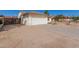 View of the garage and driveway with a side gate at 6602 W Desert Cove Ave, Glendale, AZ 85304