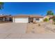 Single-story home with a two-car garage and desert landscaping at 6602 W Desert Cove Ave, Glendale, AZ 85304