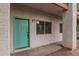 Exterior view of condo building showcasing teal door and walkway at 6920 E 4Th St # 103, Scottsdale, AZ 85251