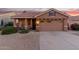 Single-story home with a two-car garage and desert landscaping at 6931 W Blackhawk Dr, Glendale, AZ 85308