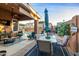 Covered patio with seating and dining area near the pool at 6931 W Blackhawk Dr, Glendale, AZ 85308